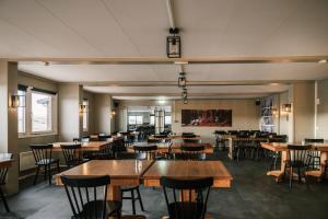 a dining room with wooden tables and chairs at The Highland Center Hrauneyjar in Sprengisandur
