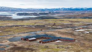 an aerial view of a building in the middle of a field at The Highland Center Hrauneyjar in Sprengisandur