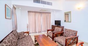 a living room with a couch and a table at Crystal Sand Mount Lavinia in Mount Lavinia