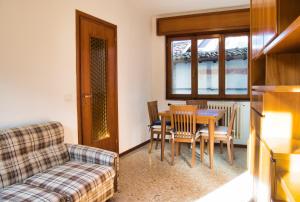 a living room with a table and chairs and a couch at Cuor di Barzio P1 in Barzio