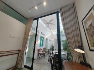 a room with glass doors and a table and chairs at Zen Retreat KL in Kuala Lumpur +34 photos