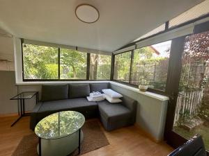 a living room with a couch and some windows at Incredible house with garden in Madrid