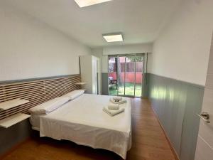 a bedroom with a bed with a tray on it at Incredible house with garden in Madrid