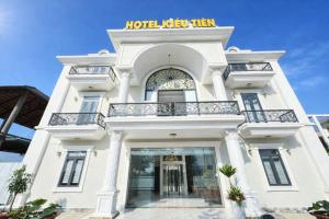 a white building with a sign that reads hotel kick them at Kiều Tiên Hotel Long Thành in Long Thành