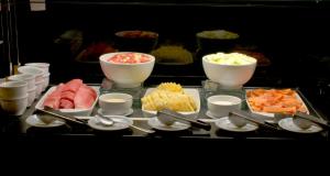 a table topped with bowls and plates of food at Holiday Inn Manaus by IHG in Manaus +72 photos