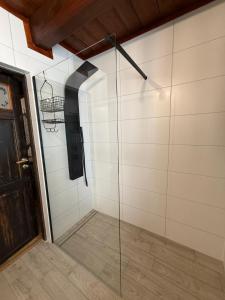 a walk in shower with a glass wall at Domek Ostoja Energylandia Zator Graboszyce in Graboszyce +14 photos