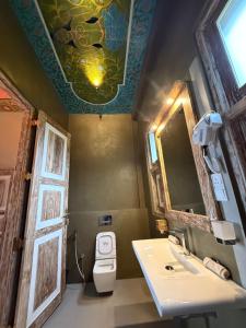 a bathroom with a toilet and a sink and a mirror at Wilson's Place in Hiriketiya