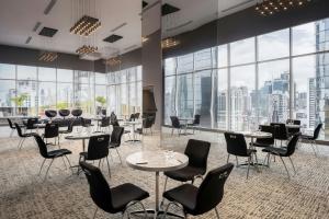 a restaurant with tables and chairs and large windows at W Panama in Panama City +65 photos