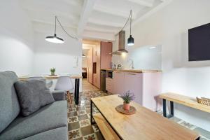 a living room with a couch and a table at FORUM EXPERIENCE Adults Only in Tarragona
