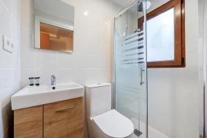a bathroom with a toilet and a sink and a shower at FORUM EXPERIENCE Adults Only in Tarragona +29 photos