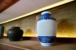 a blue and white vase sitting on a table at BLUE HOUSE - Traditional Home - 5min, Beach, Bus, Train in Beppu