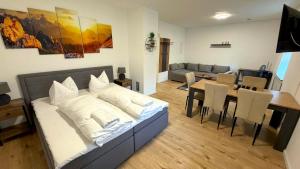 a living room with a bed and a dining room at Bitterfeld Apartment modern & gemütlich in Holzweißig
