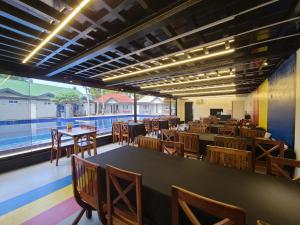 a restaurant with tables and chairs and a large window at Island Sea One Resort in Panglao Island