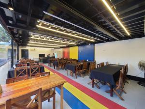 a dining room with wooden tables and chairs at Island Sea One Resort in Panglao Island