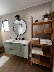 a bathroom with a sink and a mirror at קיבוץ שדה נחום Green House in Sede Naẖum +34 photos