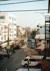 a view of a city street with a white van at Calm Stay & Cafe in Chiang Mai