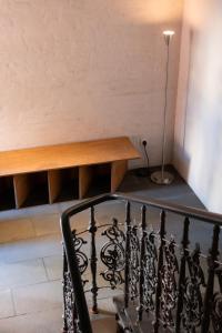 a stair case with a table and a lamp at Bellhop Tbilisi in Tbilisi City +63 photos