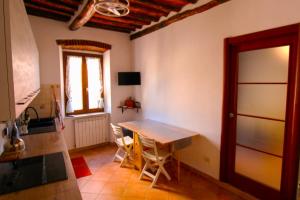 a kitchen with a table and a table and a window at Casa Carlo in Rio Marina