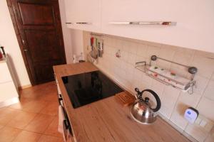 a kitchen with a counter top with a tea kettle at Casa Carlo in Rio Marina +13 photos