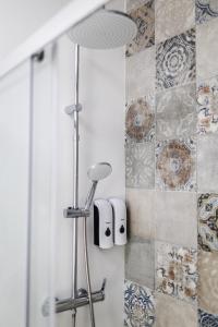a bathroom with a shower with a stool at Apartamentos Cayetana in Badajoz +51 photos