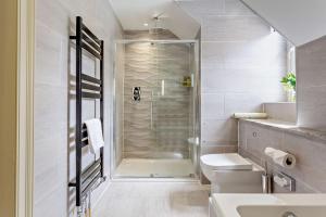a bathroom with a shower and a toilet and a sink at Muckrach Country House in Skye of Curr +101 photos