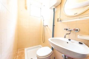 a small bathroom with a toilet and a sink at Apartmani Danijela in Stara Novalja +15 photos