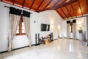 a large living room with a television and a floor at Villa Amora Hikkaduwa in Hikkaduwa +39 photos