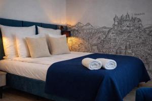 a bedroom with a bed with towels on it at InPoint Central Apartments Old Town&Kazimierz - Free Parking in Krakow