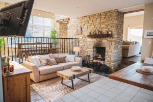 a living room with a couch and a fireplace at Smiley's Cottage in Doagh