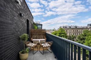a patio with two chairs and a table on a balcony at InPoint Central Apartments Old Town&Kazimierz - Free Parking in Krakow +46 photos