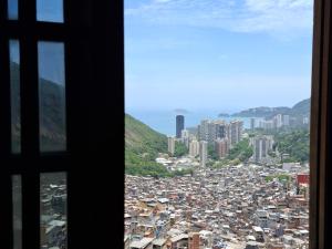 a view of a city from a window at Casa da Angela Quarto Triplo in Rio de Janeiro +1 photo