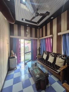 a living room with a couch and a table at Triveni Bliss in Prayagraj
