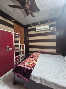 a bedroom with a bed and a ceiling fan at Triveni Bliss in Prayagraj