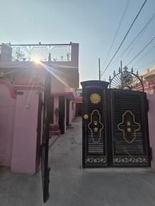 two black doors with gold crosses on them on a street at Triveni Bliss in Prayagraj