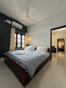 a bedroom with a large bed in a room at DOWN TOWN HOLIDAYS Kovalam in Kovalam