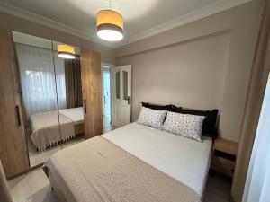 a bedroom with a large bed and a mirror at No 8 Suite in Alanya