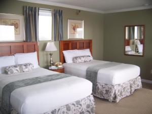 um quarto de hotel com duas camas e duas janelas em Sunrise Motel em York