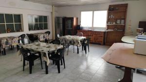 a kitchen with tables and chairs in a room at FONDO VERSACE in Reggio di Calabria