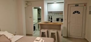a kitchen with a table and a counter with stools at Apartmani Luan in Vis +25 photos