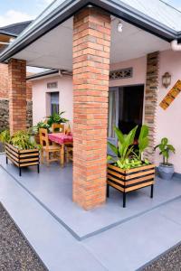 a patio with a table and chairs on a house at COLIBRI VILLA City Center in Gisenyi +2 photos