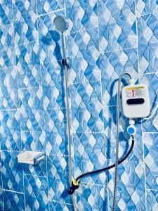 a blue and white tiled bathroom with a shower at Residence Gold in Man +58 photos