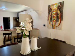 a dining room table with a painting of an elephant at L'Anse des Amarantes in Saly Portudal