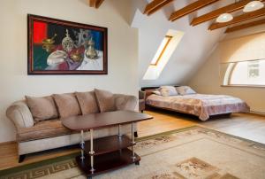 a living room with a couch and a bed at Aismares in Klaipėda +42 photos
