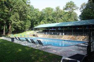 a group of chairs sitting next to a swimming pool at Coosawattee River Resort in Ellijay