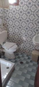 a bathroom with a toilet and a sink at Flowers studios in Benitses