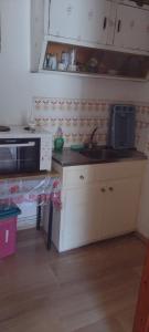 a kitchen with a sink and a microwave at Flowers studios in Benitses +27 photos