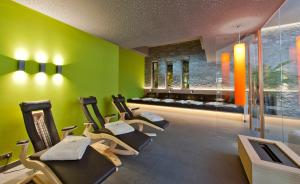 a gym with a row of exercise bikes in a room at Christophs Hotel in Schenna