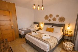 a bedroom with two beds with towels on them at Natural view villa with private pool in Skouloúfia