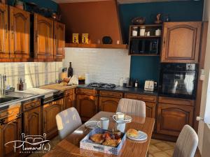 a kitchen with a table with a tray of food on it at Plumards, maison d'invités proche Abbaye in Argoules +12 photos