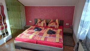 a bedroom with a bed with two pillows on it at Ferienwohnung Pölzlbauer in Neuwald